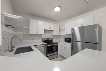 Kitchen with refrigerator at Grand Central Market Apartments, California
